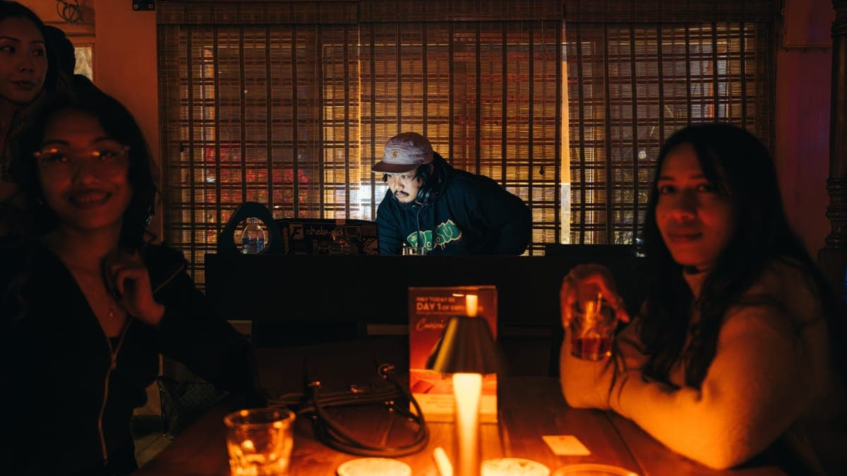 DJ performing with guests enjoying the vibe at KohBar