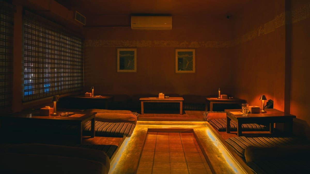 KohBar low seating lounge with bamboo blinds and warm underglow lighting